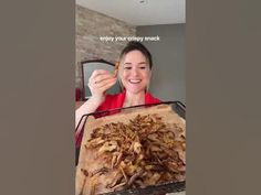 a woman holding a basket full of dried mushrooms in front of her face and the caption reads, enjoy your crispy snack