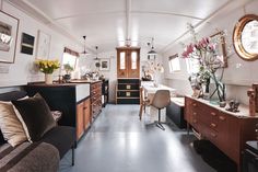 a living room filled with furniture and lots of windows