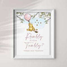 a winnie the pooh print hanging on a wall next to a white framed frame