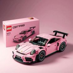 a pink lego porsche gtr is shown in front of a box with it's hood up