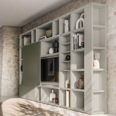 a large white bookcase with many books on it's shelves in a room