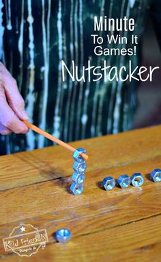 a person is playing with legos on a wooden table and has the words, minute to win it games nutsacker