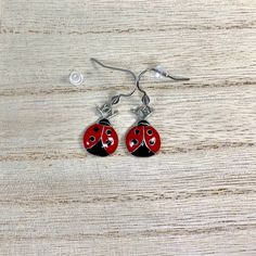 Red and Black Ladybug Charms on Surgical Stainless Steel ear wires All hook style earrings come with Silicone stoppers Measures:  just over 1/2 inch long and just under 1/2 inch wide  Enamel Zinc Alloy Charms are lead, cadmium and nickel free! Comes in small gift box Ships in 1 to 3 days, Orders over $35 ship free within the USA! To see what else I offer: https://www.etsy.com/shop/treasures2cherish Red Metal Earrings, Red Hypoallergenic Metal Jewelry, Hypoallergenic Red Metal Jewelry, Red Pierced Enamel Earrings, Red Enamel Pierced Earrings, Adjustable Enamel Earrings With Ear Wire, Hypoallergenic Red Metal Earrings, Red Enamel Earrings, Red Hypoallergenic Drop Earrings