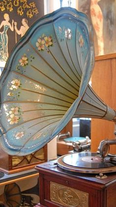 an old fashioned record player sitting on top of a table