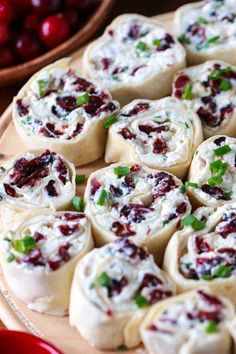 cranberry cheese rolls on a plate with fresh cherries in the back ground