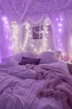 a bed with white sheets and lights on the ceiling