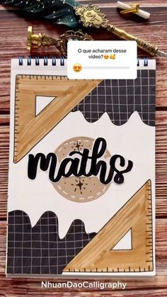 a notebook with the word maths written on it next to a pen and scissors