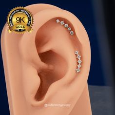 an image of a fake ear with three stones on it's side and the word gk gold