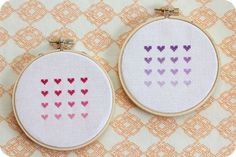 two cross stitch hoops with hearts on them