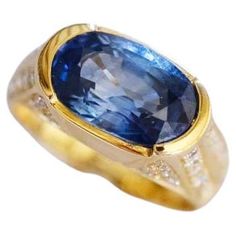 a gold ring with a large blue stone