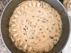 a metal bowl filled with food on top of a counter