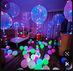 a room filled with balloons and lights on the floor