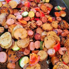 there are many different types of food on the grill together, including potatoes and carrots