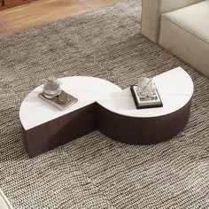 a white coffee table sitting on top of a rug