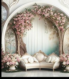 an ornate living room decorated with pink flowers and greenery, along with white couches