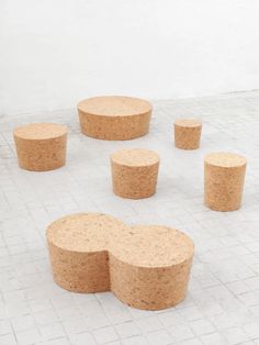 several pieces of cork sitting on top of a white brick floor next to each other