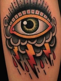 an eye with lightning coming out of it's center and on top of the leg