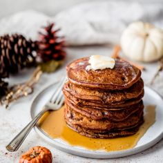 a stack of pancakes sitting on top of a white plate