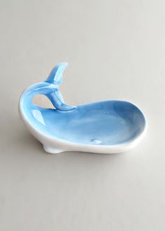 a blue whale shaped bowl sitting on top of a table