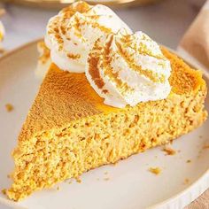 a slice of pumpkin pie on a plate with whipped cream and cinnamon crumbs