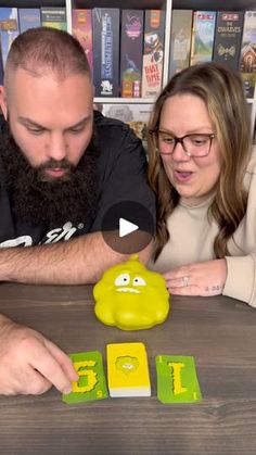 a man and woman playing games on a table