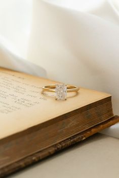 a ring sitting on top of an open book