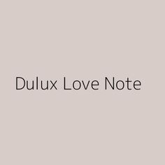 the words dulux love note are black and white on a light gray background,