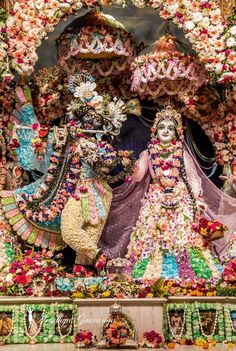 an elaborately decorated stage with statues and flowers