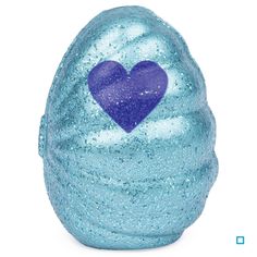 a blue bath bomb with a heart on it's side, against a white background