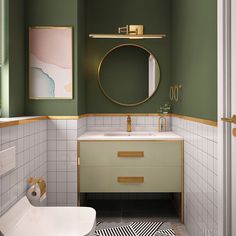 a bathroom with green walls and white tile on the floor, along with a gold framed mirror