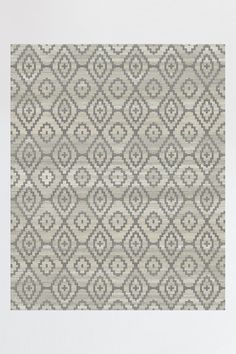 a gray and white rug with an abstract design