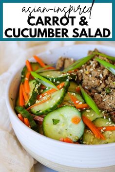 a white bowl filled with carrots and cucumber salad on top of a table