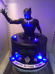 a black panther birthday cake with blue lights