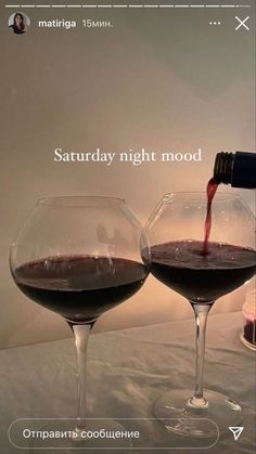 two wine glasses with red wine being poured into them, and the words saturday night mood written in english