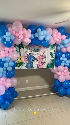 a balloon arch with blue, pink and white balloons in the shape of an elephant