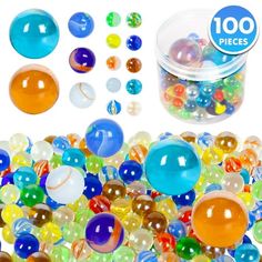 a container filled with lots of different colored marbles next to a pile of plastic balls