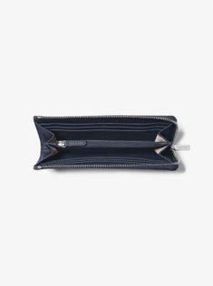 A compact accessory with maximum style, consider this sleek wallet for days that require on-the-go ease. Crafted from rich Saffiano, its slim silhouette partially unzips to reveal multiple card slots and a center compartment perfect for just the essentials. Slip it into the coordinating tote. Classic Travel Wallet With Zipper Closure, Modern Travel Wallets With Zipper Closure, Modern Bifold Wallet With Zipper Closure, Modern Compact Wallet With Zipper, Zip Wallet, Kors Jet Set, Jet Set, Michael Kors Jet Set, Quarter Zip