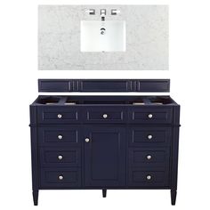 a white sink sitting under a mirror next to a dark blue cabinet and counter top