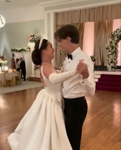 a bride and groom are dancing together on the dance floor