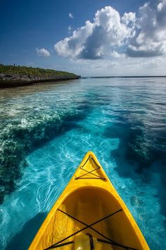 a yellow kayak in the middle of clear blue water