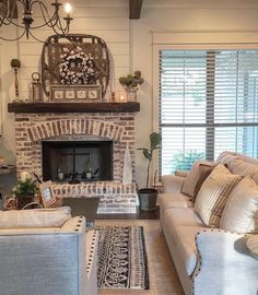 a living room with two couches and a fire place in it's center