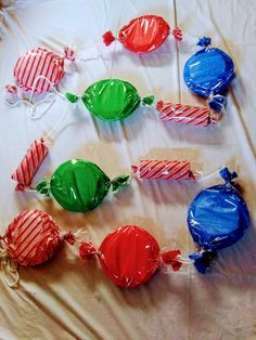 candy lollipops wrapped in cellophane on a bed