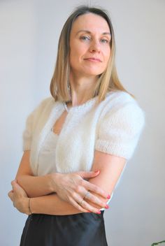 a woman standing with her arms crossed