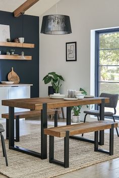 a dining room table with two benches next to it