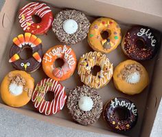 a box filled with lots of different flavored donuts