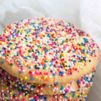 three cookies with sprinkles stacked on top of each other