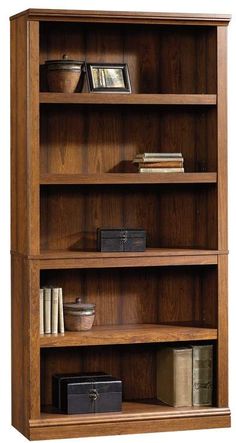 a wooden bookcase with three shelves filled with books