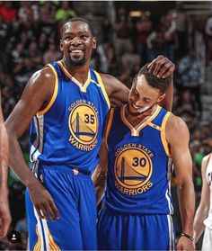 two basketball players standing next to each other