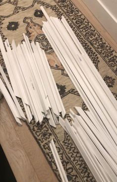 several pieces of white paper sitting on top of a rug next to a door frame