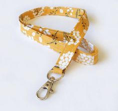 a yellow leash with white flowers on it